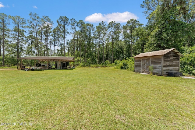 34100 Old Baldwin Rd, Callahan, FL 32011 - view of green lawn with a detached carport and a storage shed