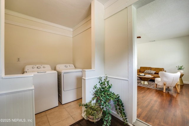 3516 Myra St, Jacksonville, FL 32205 - washroom with washer and clothes dryer, wainscoting, crown molding, and light wood finished floors