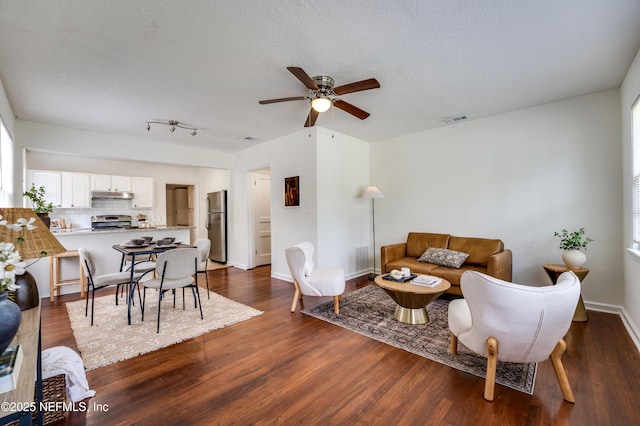 3516 Myra St, Jacksonville, FL 32205 - living room featuring a ceiling fan, dark wood-style floors, and a textured ceiling