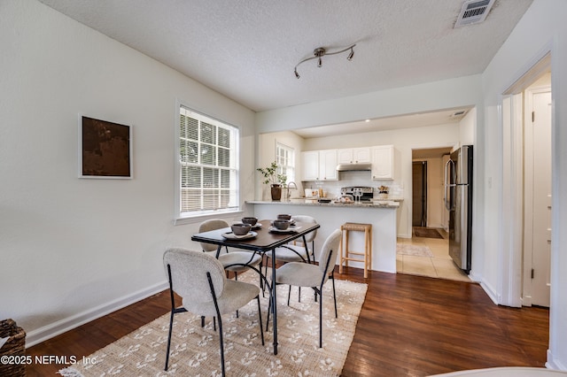 3516 Myra St, Jacksonville, FL 32205 - dining area featuring wood finished floors and a textured ceiling