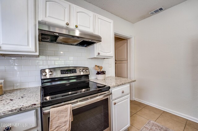3516 Myra St, Jacksonville, FL 32205 - kitchen with electric stove, under cabinet range hood, white cabinets, decorative backsplash, and a textured ceiling