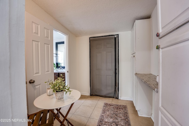 3516 Myra St, Jacksonville, FL 32205 - entryway with light tile patterned flooring and a textured ceiling