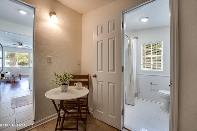 3516 Myra St, Jacksonville, FL 32205 - full bath featuring a textured wall, ceiling fan, tile patterned flooring, curtained shower, and a textured ceiling