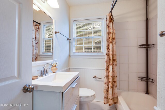 3516 Myra St, Jacksonville, FL 32205 - full bathroom with vanity, wainscoting, and shower / bath combo with shower curtain