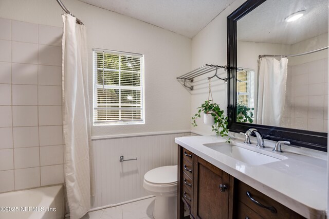 3516 Myra St, Jacksonville, FL 32205 - full bathroom with vanity, shower / bath combination with curtain, and wainscoting