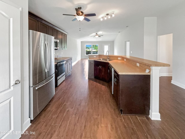 6191 Daylilly Rd, Macclenny, FL 32063 - kitchen with appliances with stainless steel finishes, ceiling fan, dark wood finished floors, dark brown cabinets, and vaulted ceiling