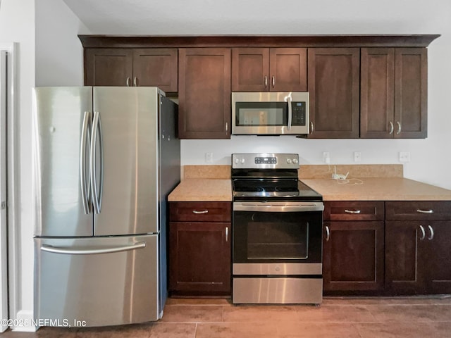 6191 Daylilly Rd, Macclenny, FL 32063 - kitchen featuring appliances with stainless steel finishes, dark brown cabinetry, and light countertops