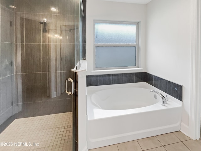 6191 Daylilly Rd, Macclenny, FL 32063 - full bathroom featuring a bath, a shower stall, and tile patterned floors