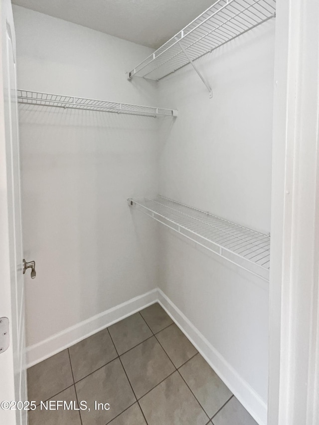 6191 Daylilly Rd, Macclenny, FL 32063 - spacious closet featuring tile patterned floors