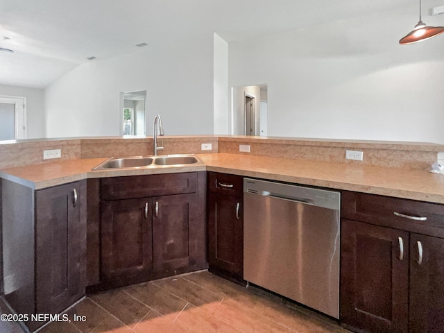 6191 Daylilly Rd, Macclenny, FL 32063 - kitchen with dishwasher, light countertops, dark brown cabinetry, dark tile patterned floors, and lofted ceiling