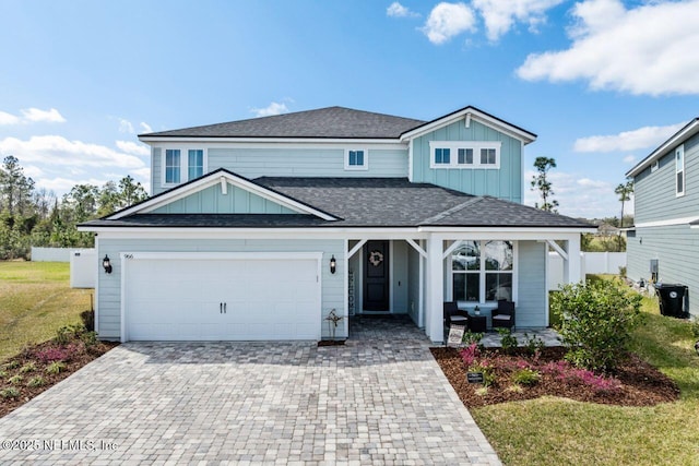 966 Rooster Hollow Way, Middleburg, FL 32068 - traditional-style home featuring board and batten siding, decorative driveway, a shingled roof, and an attached garage