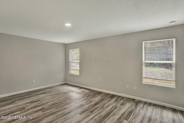 5050 San Juan Ave, Jacksonville, FL 32210 - unfurnished room with wood finished floors, a textured ceiling, and recessed lighting