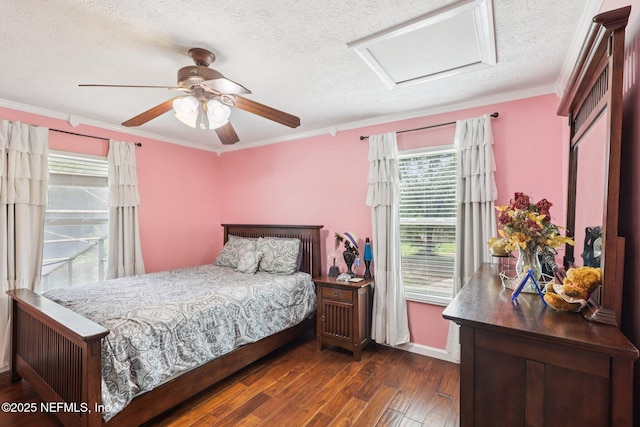 1071 Foxmeadow Trl, Middleburg, FL 32068 - bedroom featuring attic access, multiple windows, dark wood-type flooring, a textured ceiling, and ornamental molding