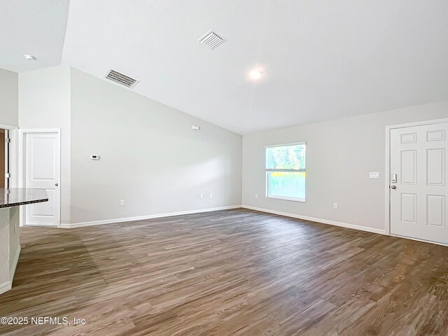 9473 N Athenia Dr, Citrus Springs, FL 34434 - spare room featuring vaulted ceiling and dark wood finished floors