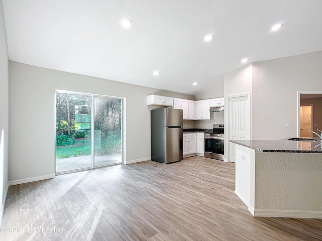 9473 N Athenia Dr, Citrus Springs, FL 34434 - kitchen with appliances with stainless steel finishes, dark stone countertops, white cabinetry, light wood-style floors, and recessed lighting