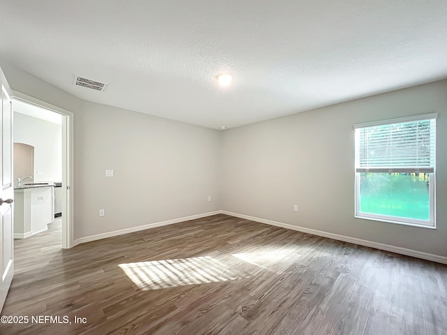 9473 N Athenia Dr, Citrus Springs, FL 34434 - unfurnished room featuring wood finished floors and a textured ceiling