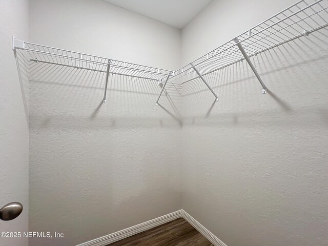 9473 N Athenia Dr, Citrus Springs, FL 34434 - walk in closet featuring dark wood-style floors