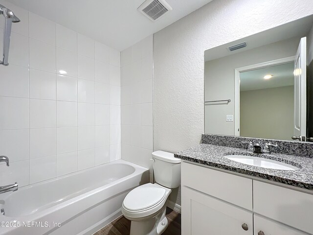 9473 N Athenia Dr, Citrus Springs, FL 34434 - bathroom with a textured wall, vanity, wood finished floors, and  shower combination