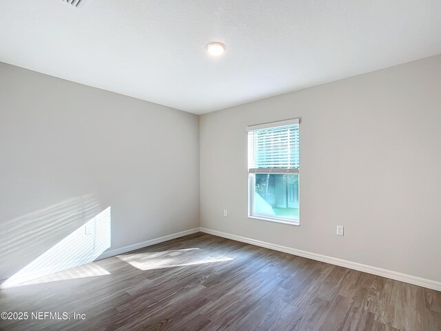 9473 N Athenia Dr, Citrus Springs, FL 34434 - empty room featuring dark wood-type flooring and baseboards