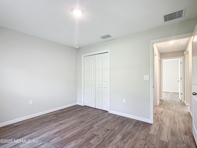 9473 N Athenia Dr, Citrus Springs, FL 34434 - unfurnished bedroom with wood finished floors and a closet