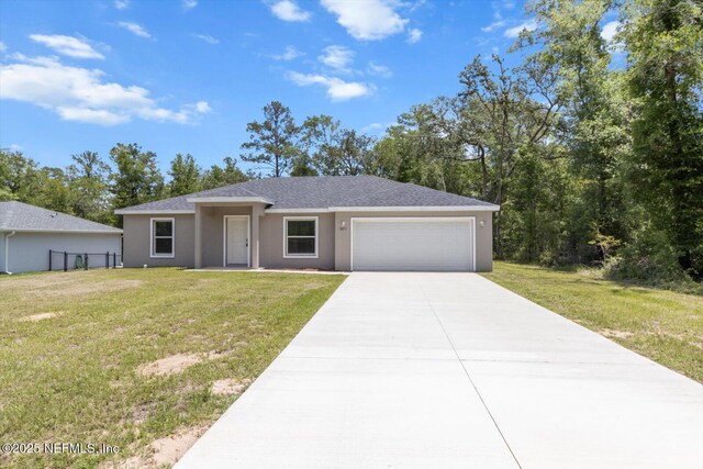 9473 N Athenia Dr, Citrus Springs, FL 34434 - ranch-style house featuring stucco siding, a garage, and a front yard