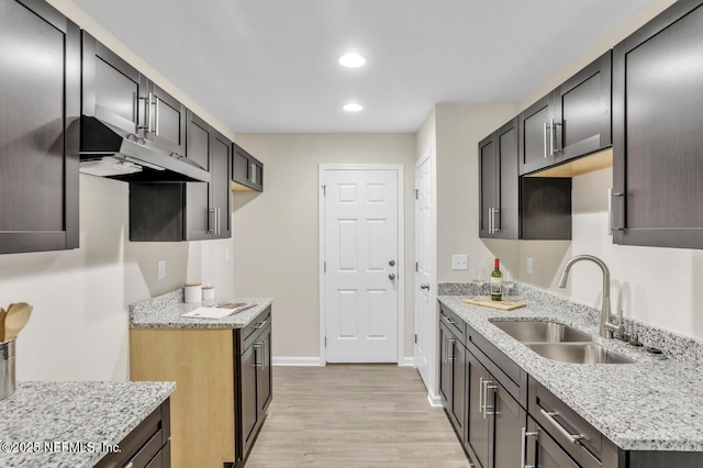 4730 Ridgewood Ave, Jacksonville, FL 32207 - kitchen with light wood-style floors, under cabinet range hood, recessed lighting, and light stone counters