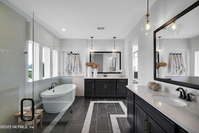 80 Oak Cluster Ln, Saint Augustine, FL 32092 - bathroom featuring a freestanding bath, two vanities, and tile patterned flooring