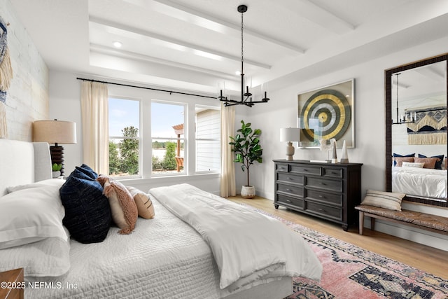 80 Oak Cluster Ln, Saint Augustine, FL 32092 - bedroom featuring wood finished floors, a chandelier, and beamed ceiling
