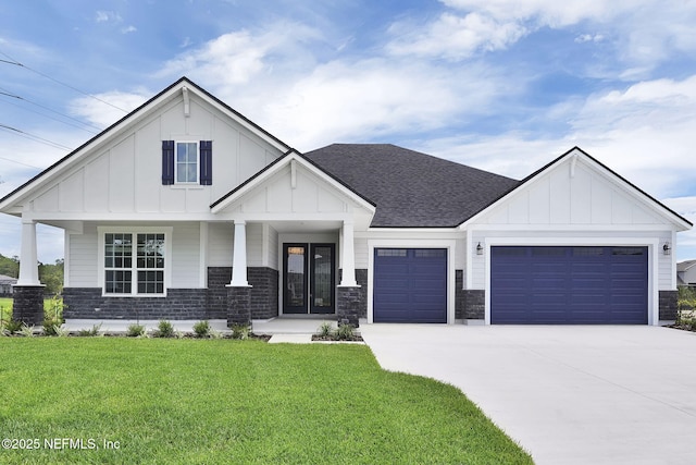80 Oak Cluster Ln, Saint Augustine, FL 32092 - view of front of home with board and batten siding, an attached garage, roof with shingles, and a front yard