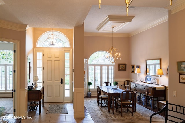 13464 Ellsworth Ln, Jacksonville, FL 32225 - entryway with a chandelier, plenty of natural light, tile patterned floors, wainscoting, and crown molding