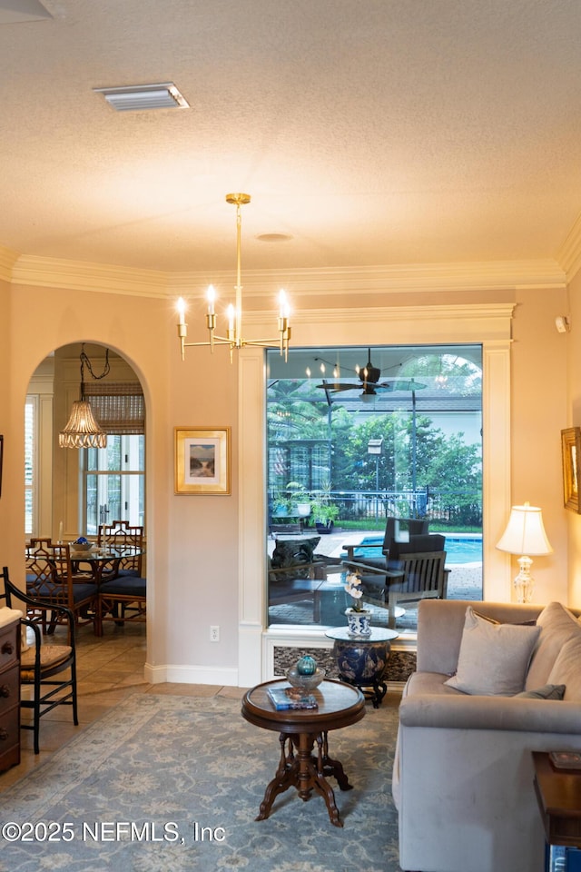 13464 Ellsworth Ln, Jacksonville, FL 32225 - tiled living room with ornamental molding, a chandelier, arched walkways, and a textured ceiling