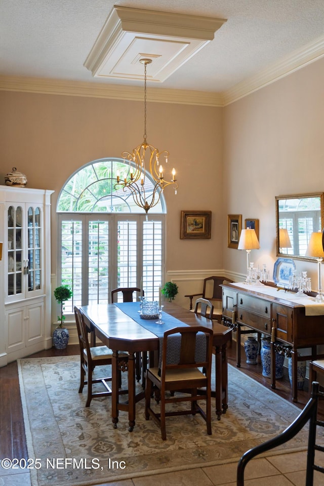13464 Ellsworth Ln, Jacksonville, FL 32225 - dining room with crown molding, wood finished floors, and a chandelier