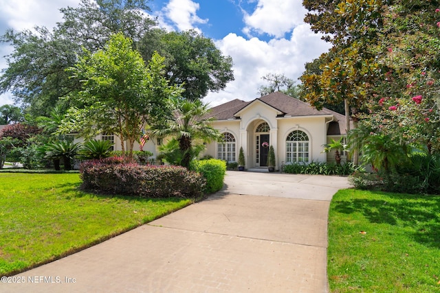 13464 Ellsworth Ln, Jacksonville, FL 32225 - view of front of home featuring stucco siding, concrete driveway, and a front yard