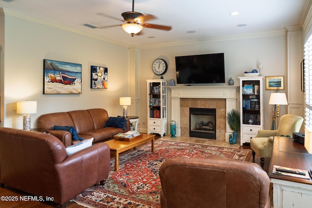 13464 Ellsworth Ln, Jacksonville, FL 32225 - living area featuring ceiling fan, a tile fireplace, crown molding, and wood finished floors