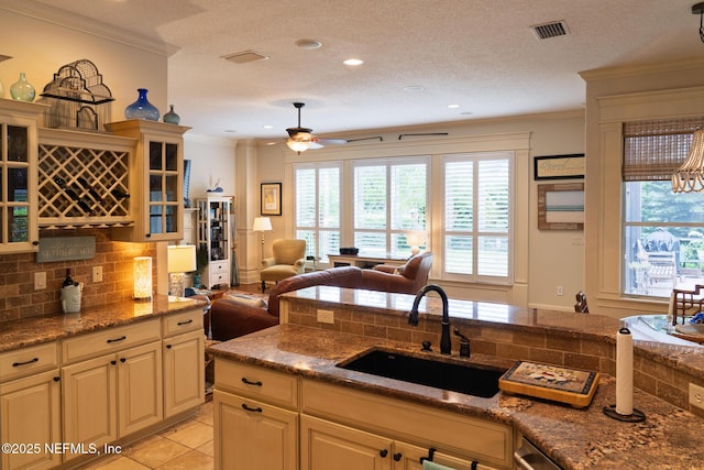 13464 Ellsworth Ln, Jacksonville, FL 32225 - kitchen with crown molding, tasteful backsplash, glass insert cabinets, ceiling fan, and open floor plan