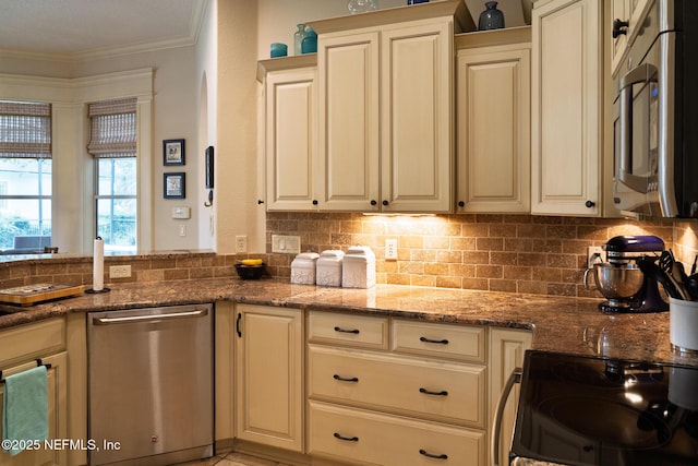 13464 Ellsworth Ln, Jacksonville, FL 32225 - kitchen featuring stainless steel appliances, ornamental molding, cream cabinetry, stone countertops, and backsplash