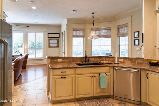 13464 Ellsworth Ln, Jacksonville, FL 32225 - kitchen with appliances with stainless steel finishes, ornamental molding, dark stone countertops, light tile patterned floors, and hanging light fixtures