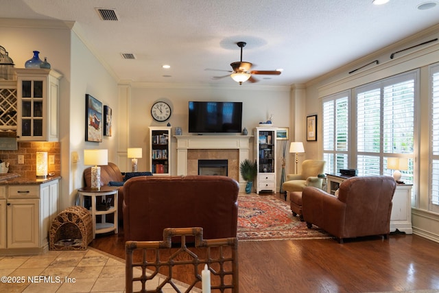 13464 Ellsworth Ln, Jacksonville, FL 32225 - living room with healthy amount of natural light, a fireplace, a ceiling fan, crown molding, and light wood-type flooring