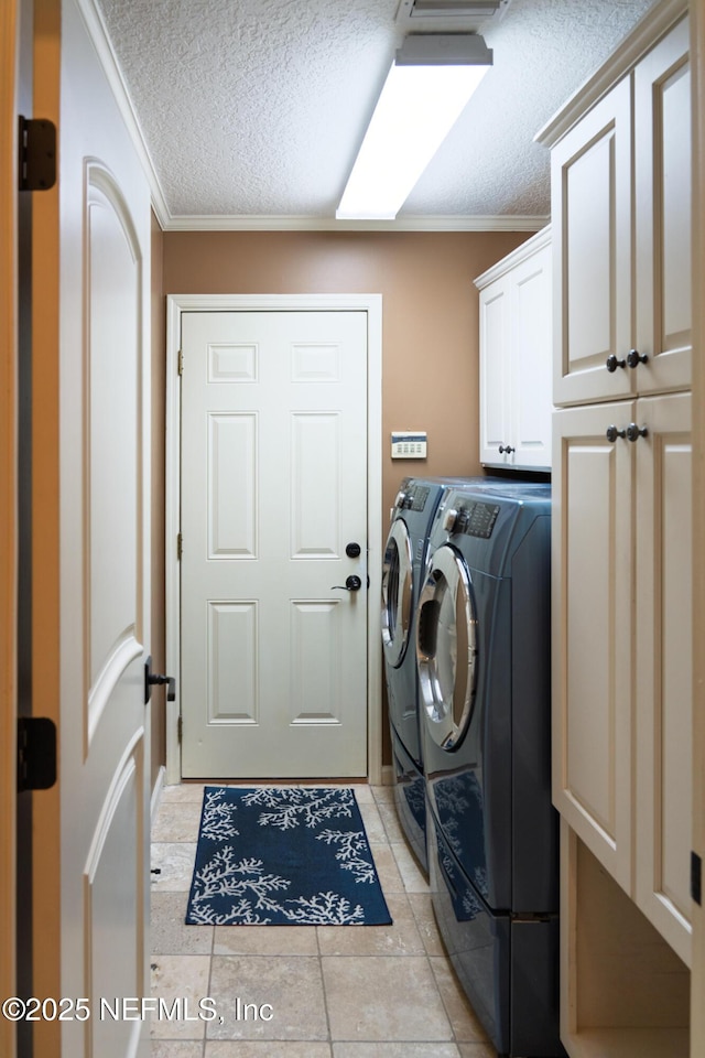 13464 Ellsworth Ln, Jacksonville, FL 32225 - washroom with washing machine and clothes dryer, cabinet space, crown molding, a textured ceiling, and light tile patterned floors