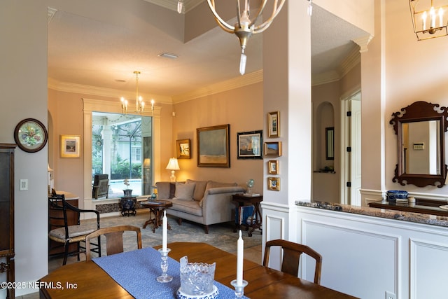 13464 Ellsworth Ln, Jacksonville, FL 32225 - dining area featuring a chandelier, crown molding, and arched walkways