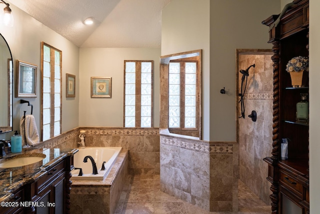 13464 Ellsworth Ln, Jacksonville, FL 32225 - bathroom featuring vaulted ceiling, a bath, vanity, a walk in shower, and tile walls