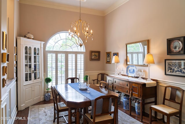 13464 Ellsworth Ln, Jacksonville, FL 32225 - dining space with wood finished floors, a chandelier, a wainscoted wall, ornamental molding, and a towering ceiling