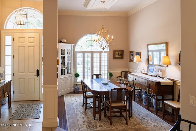 13464 Ellsworth Ln, Jacksonville, FL 32225 - dining area featuring a chandelier, a high ceiling, ornamental molding, and wainscoting