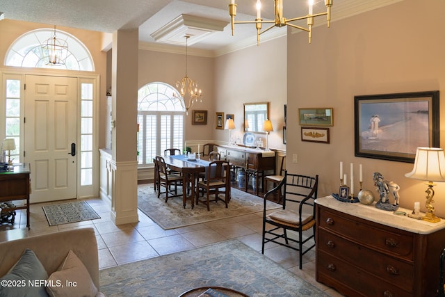 13464 Ellsworth Ln, Jacksonville, FL 32225 - entrance foyer with a chandelier, ornamental molding, a high ceiling, plenty of natural light, and light tile patterned floors