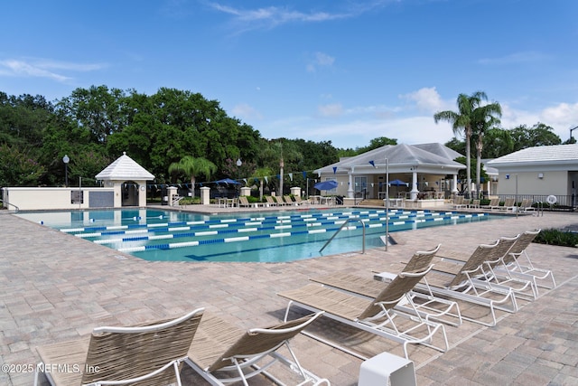 13464 Ellsworth Ln, Jacksonville, FL 32225 - community pool featuring a patio and view of wooded area