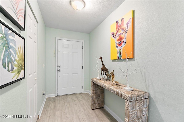 2404 Vista Cove Rd, Saint Augustine, FL 32084 - foyer entrance featuring light wood-style floors and a textured ceiling