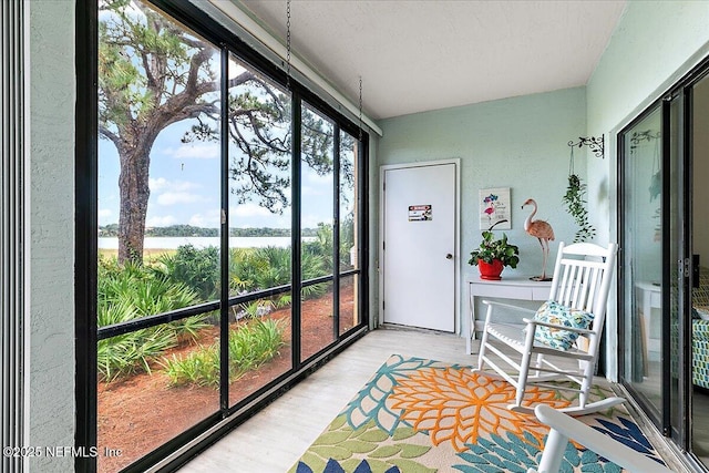 2404 Vista Cove Rd, Saint Augustine, FL 32084 - sunroom / solarium featuring a water view, wood finished floors, and a textured wall
