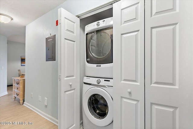 2404 Vista Cove Rd, Saint Augustine, FL 32084 - laundry area featuring stacked washer / drying machine, light wood-style floors, and electric panel