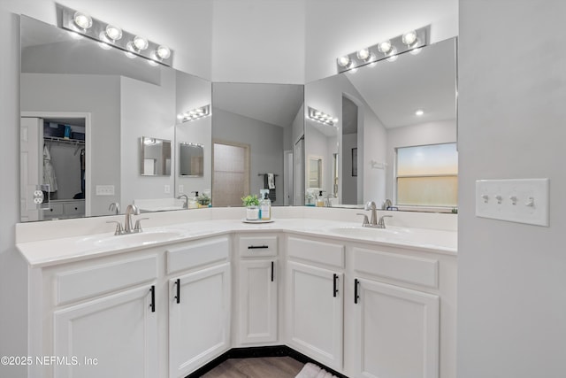 2250 Trailwood Dr, Fleming Island, FL 32003 - bathroom featuring double vanity and lofted ceiling