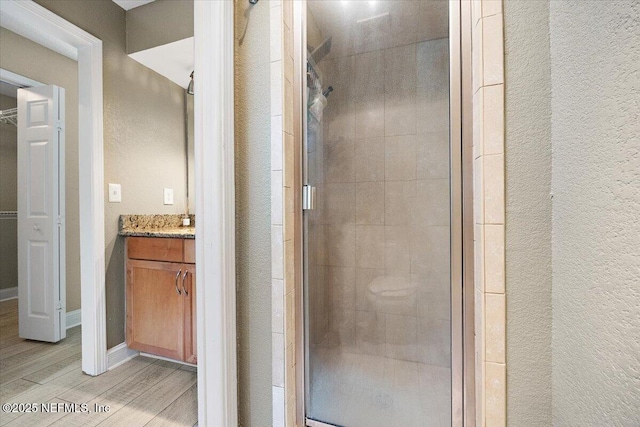 730 Tidewater Ct, Ponte Vedra Beach, FL 32082 - bathroom with vanity, a shower stall, wood finished floors, and a textured wall